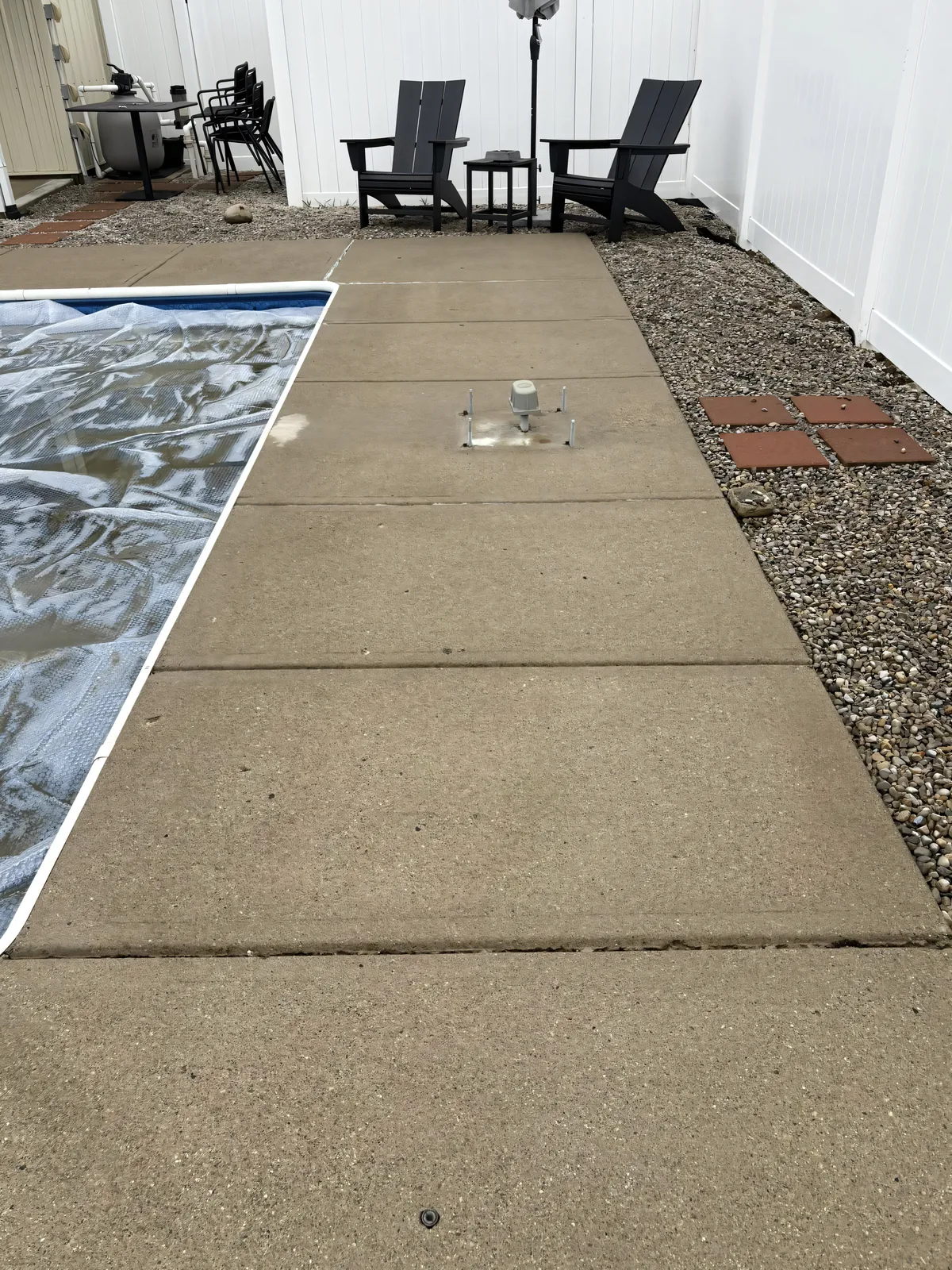 Same concrete patio surface after Stoltz pressure washing — clean, restored original color